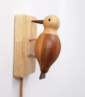 A charming wooden woodpecker doorbell with a color-blocked style